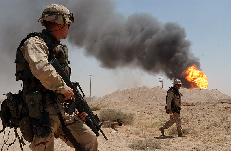 800px-US_Navy_030402-N-5362A-004_U.S._Army_Sgt._Mark_Phiffer_stands_guard_duty_near_a_burning_oil_well_in_the_Rumaylah_Oil_Fields_in_Southern_Iraq