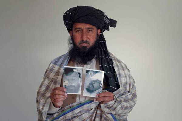 Kareem Khan with picture of his son, killed by a drone. Credit: Noor Behram/Reprieve