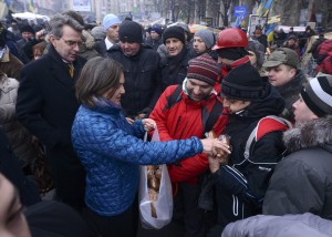 U.S. Assistant Secretary of State for European and Eurasian Affairs Nuland distributes bread to protesters next to U.S. Ambassador Pyatt at Independence square in Kiev
