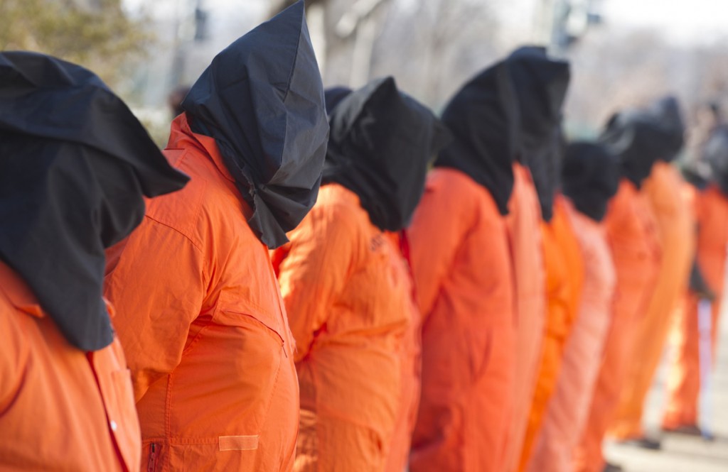 Protestors-wear-orange-prison-jumpsuits-and-black-hoods-on-their-heads-during-protests-against-holding-detainees-at-the-military-prison-in-Guantanamo-Bay-during-a-demonstration-on-Capitol-Hill-in-Washington-D.C.-on-January-8-2