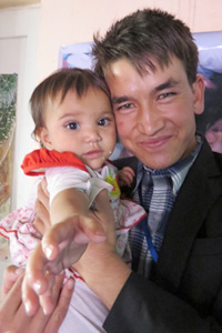 Ali, one of the Afghan Peace Volunteers who assisted the five Kunduz families, including the toddler named Rana in the photo